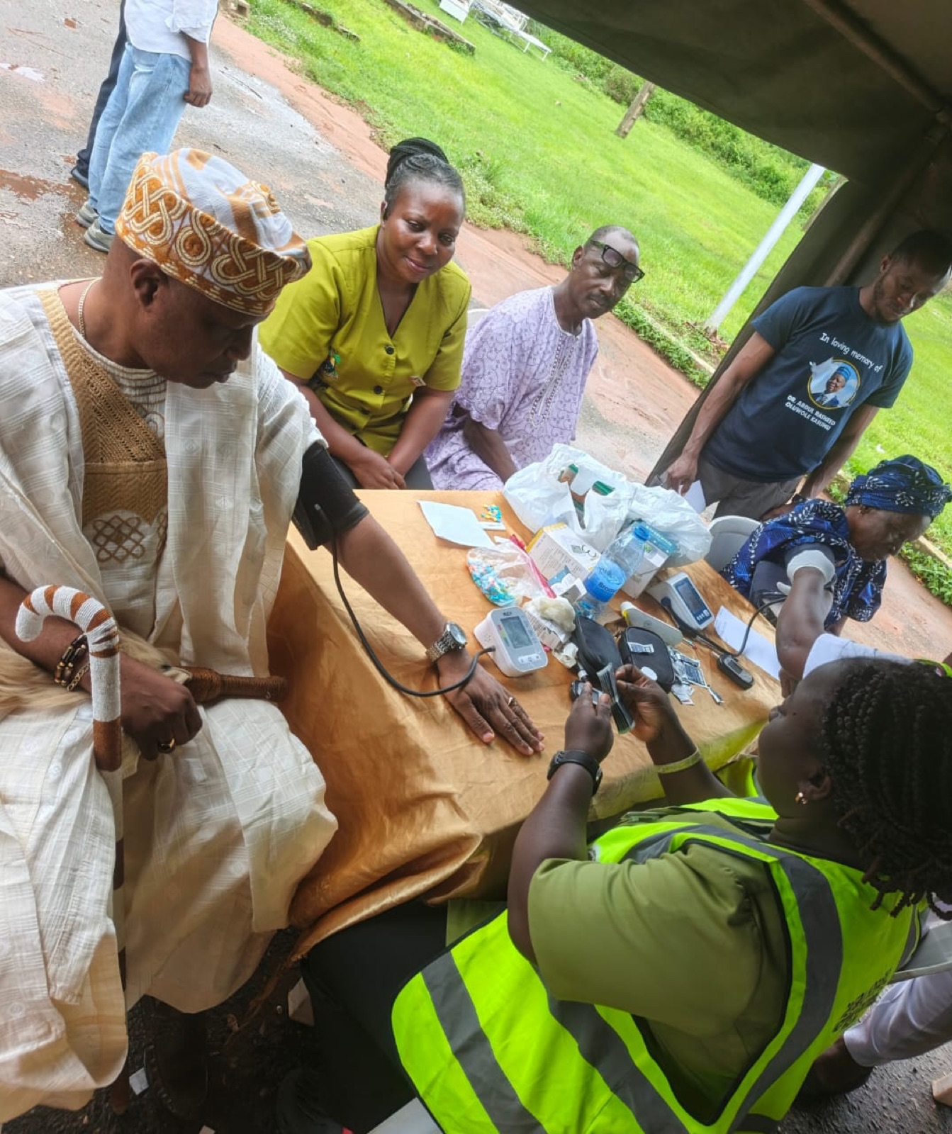 The Abowa of Agbowa-Ikosi receiving a blood pressure check from KBB volunteers