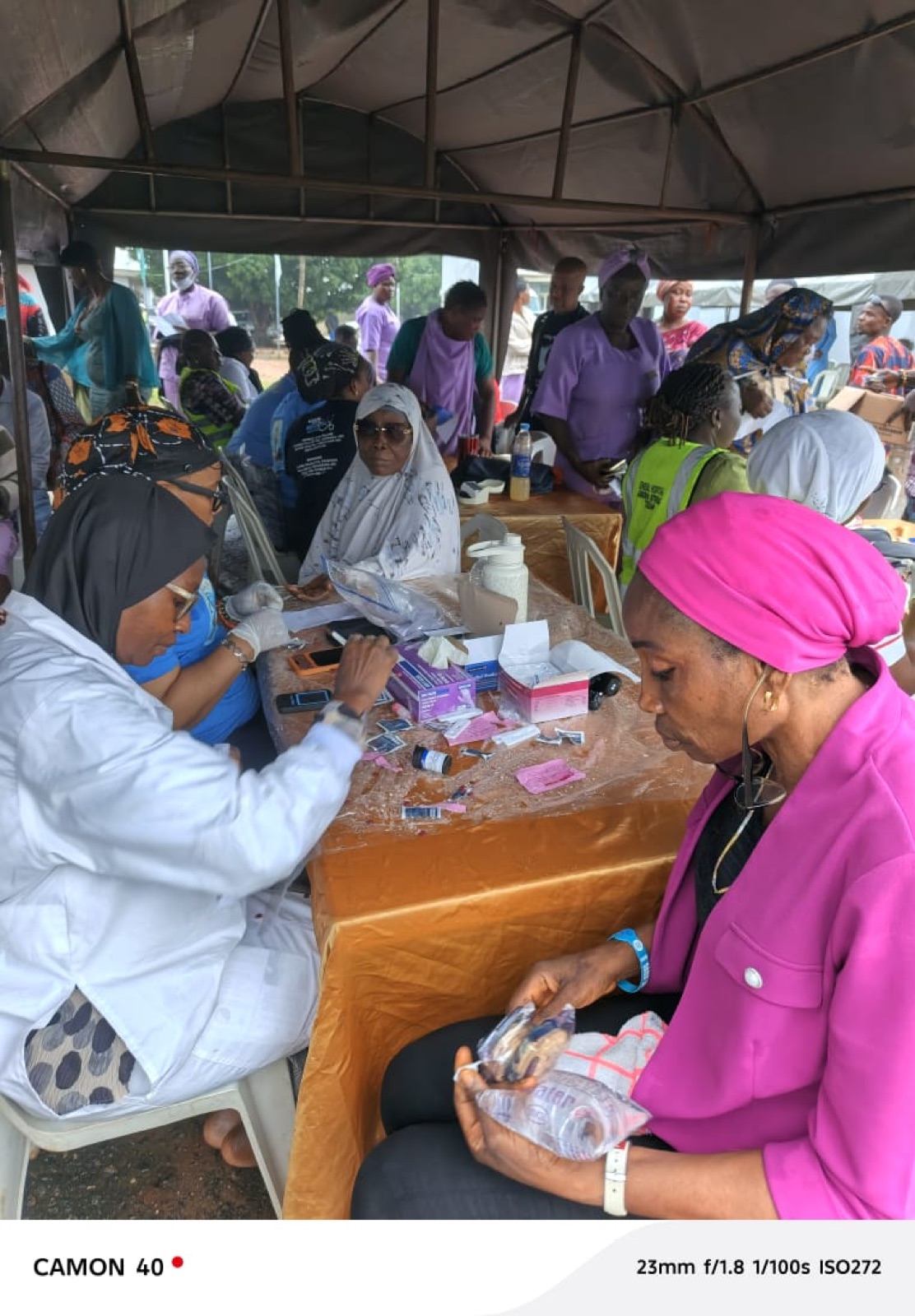 A community member being fitted with reading glasses at the Agbowa-Ikosi mission