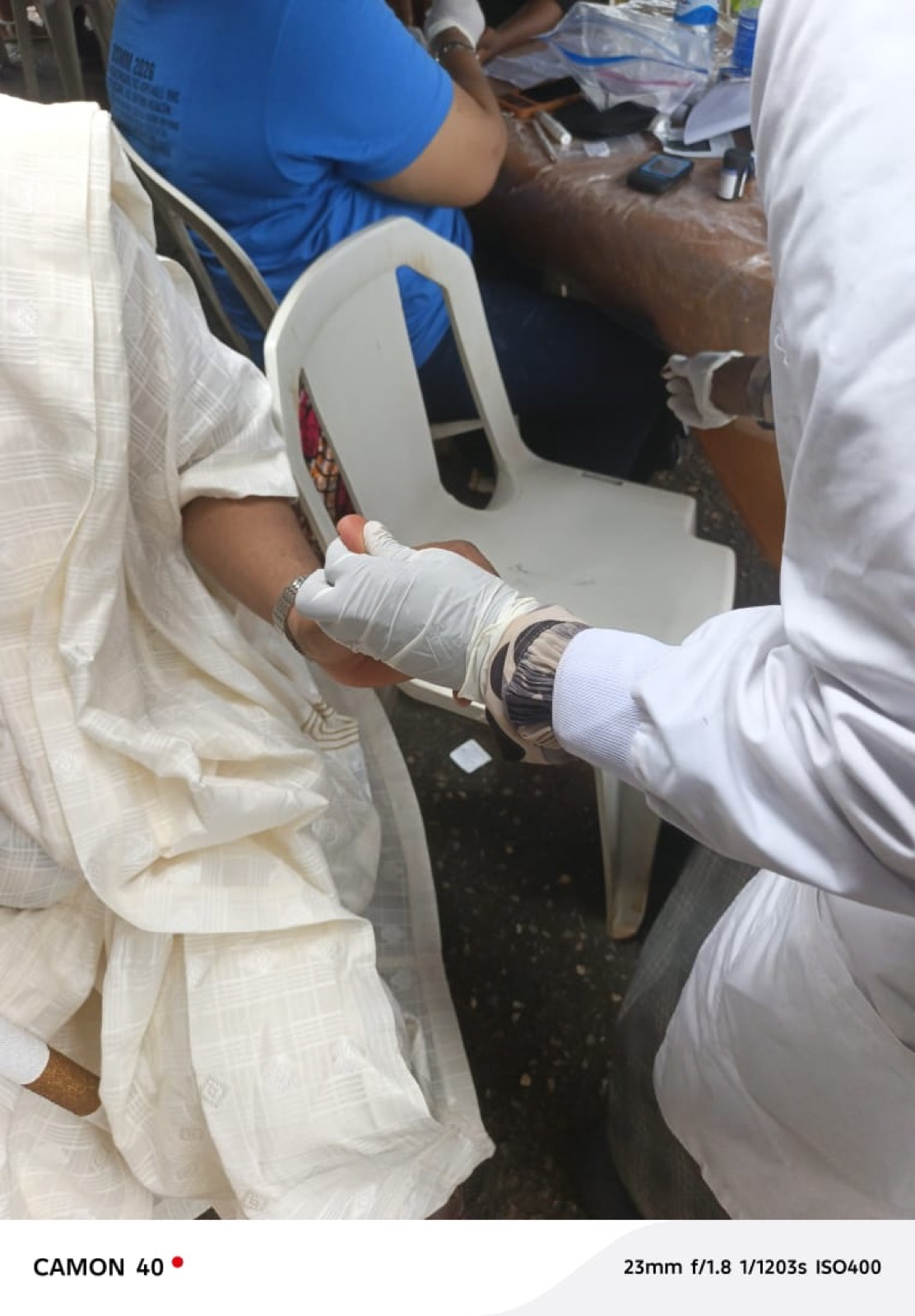 A volunteer providing wound care treatment at the Agbowa-Ikosi mission
