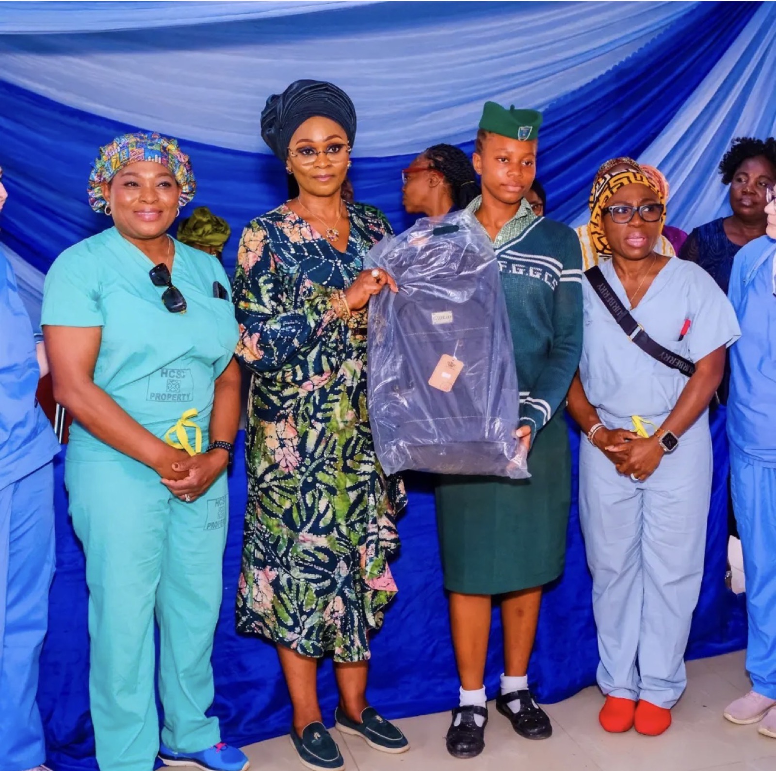 A student receiving a donated school bag at Federal Government Girls' College, Sagamu, 2026