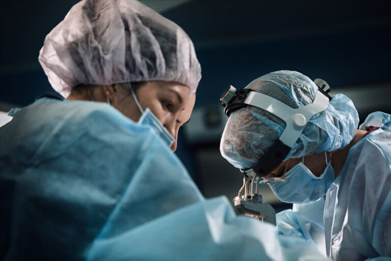 An international surgical team in the operating room, representing KBB's cancer surgery program